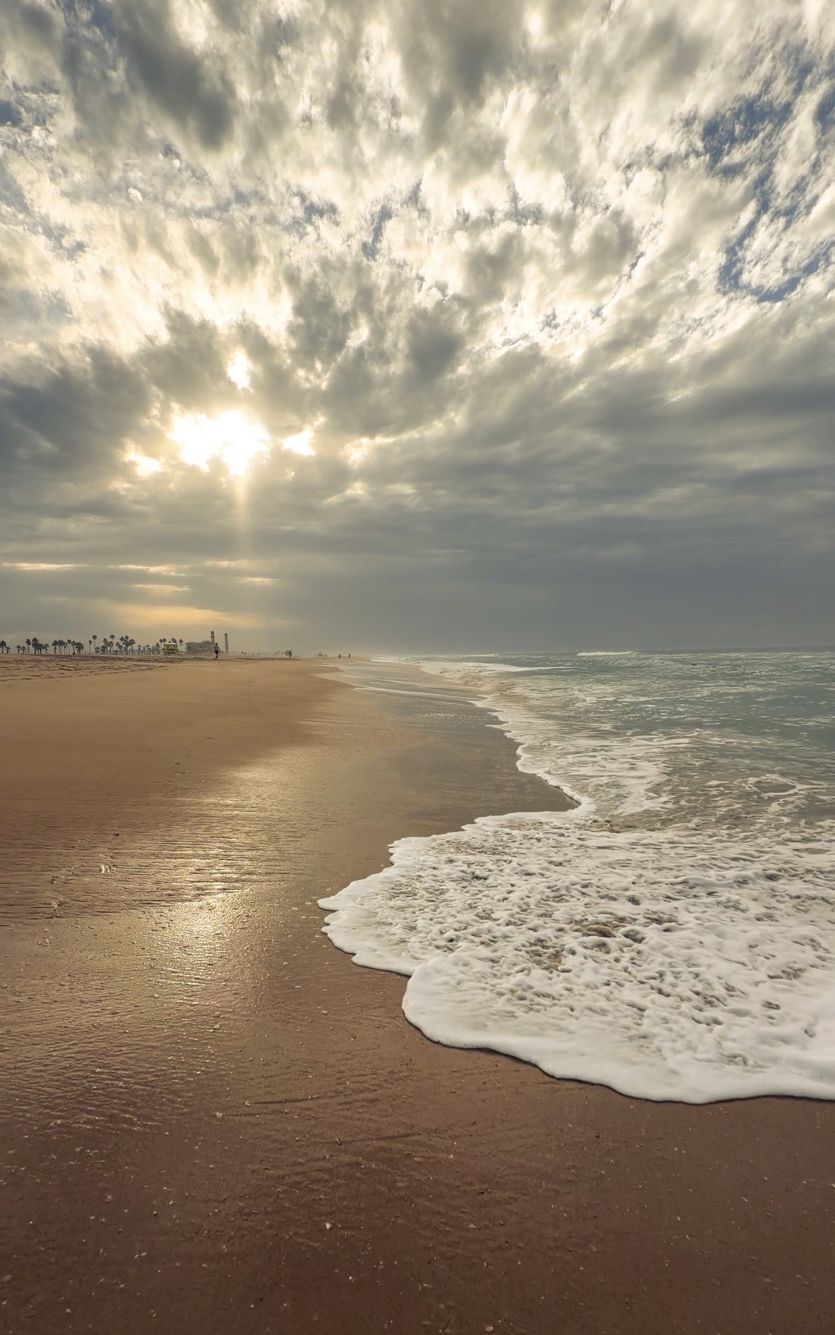 Huntington Beach in the morning, with waves on the sand